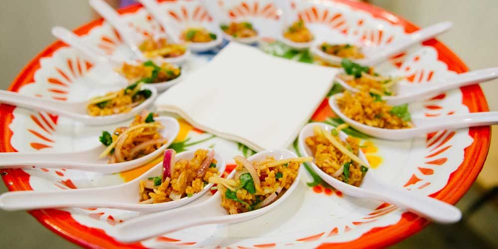 A plate of spoons containing small bites at the Night Market in Los Angeles. 