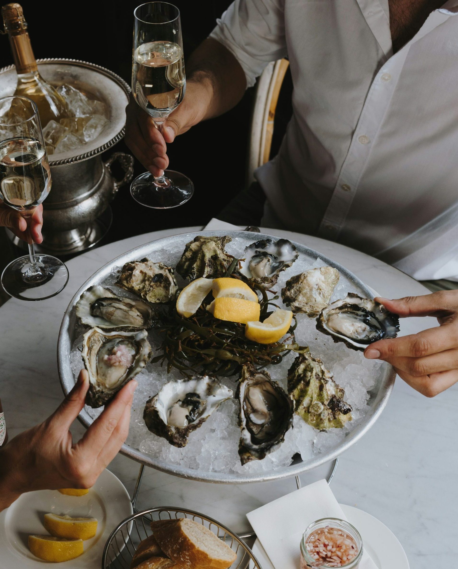 Two People Enjoying Oysters and Wine